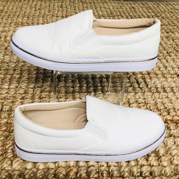 white sneakers with gold trim